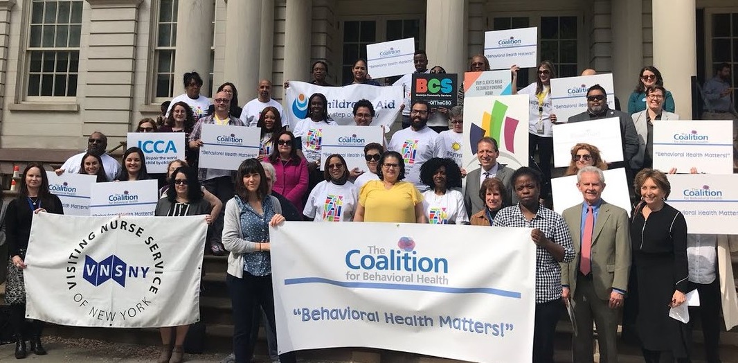 CEO Amy Dorin, Board Vice President David Woodlock (ICL) and member agencies join Council Members Diana Ayala and Brad Lander on the steps of City Hall for a rally in support of increased funding for behavioral health programs.